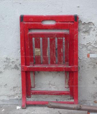 red-chair-against-white-wall